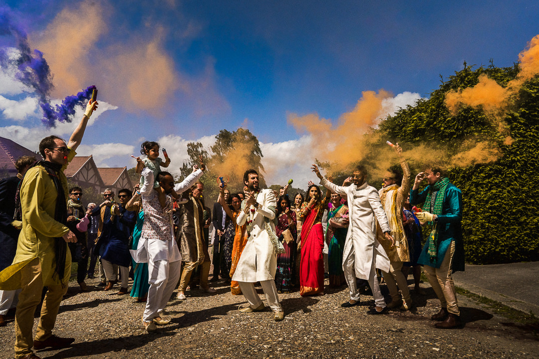 smoke bombs and drums during an Indian groom procession 