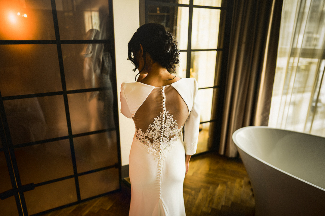 a bride just after putting on her wedding dress at the Novotel in Canary Wharf London