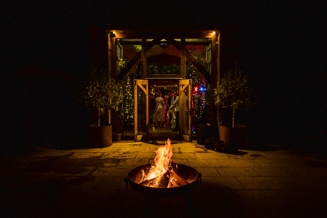 a night time shot of a fire pit outside Cripps stone barn in The Cotswolds