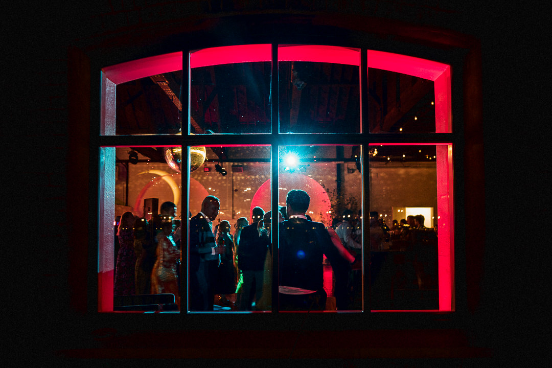 a nighttime dance floor shot through the windows at trinity buoy wharfs chain store in East London 